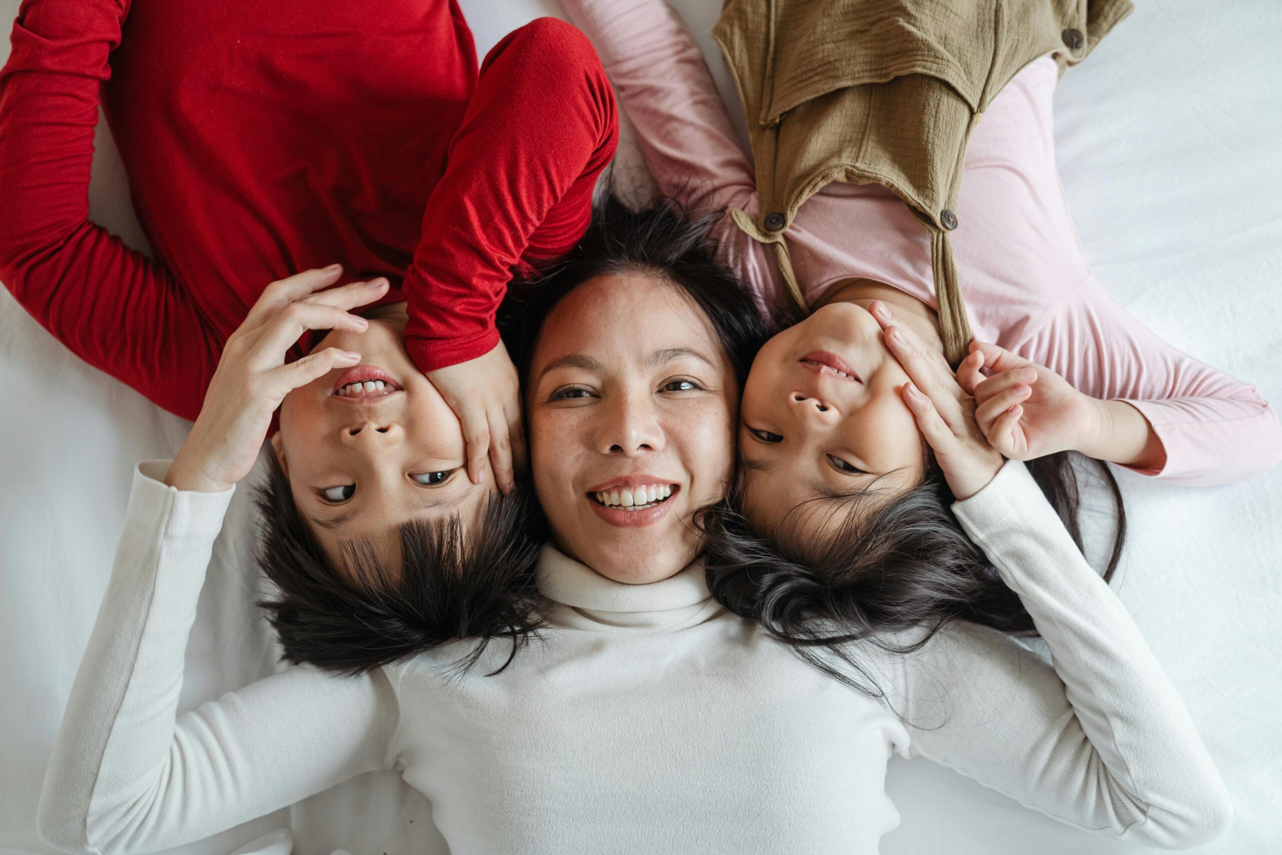 mum and two kids smiling - ketut-subiyanto